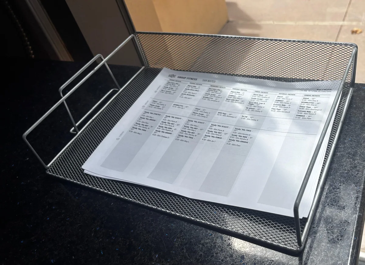 Printed Crunch San Mateo class schedule displayed at the front desk